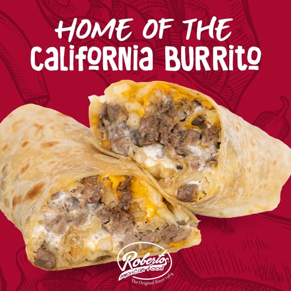 A Roberto's Mexican Food California Burrito, cut in half, revealing steak, cheese, and sour cream.